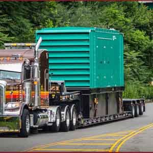 Load rigging expertise is used to secure heavy oversize loads like industrial equipment on the back of this trailer leaving Wooster, Ohio